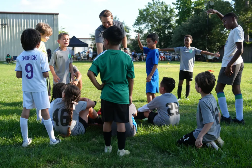 NEXO Tots players with their coach